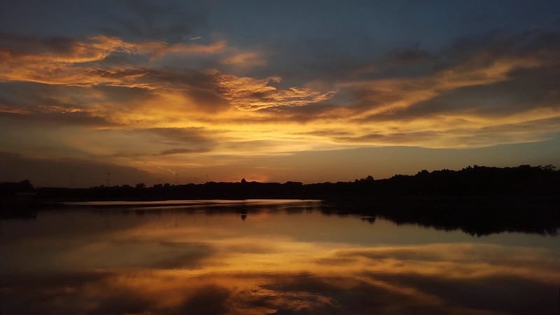 The sky is yellow and orange when sunset